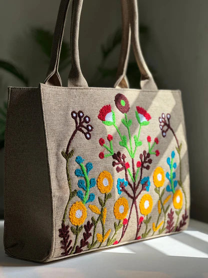 Tote bag with floral embroidery on a neutral background